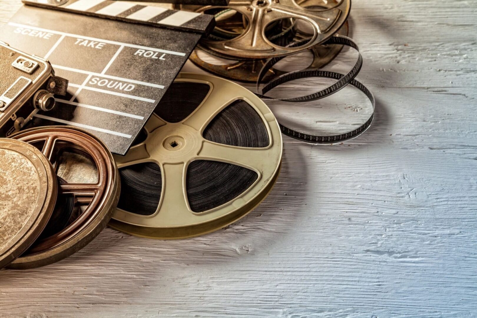 Film camera chalkboard and roll on wooden table